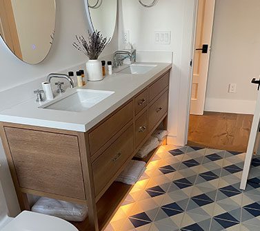 Bright bathroom interior with honey vanity cabinet